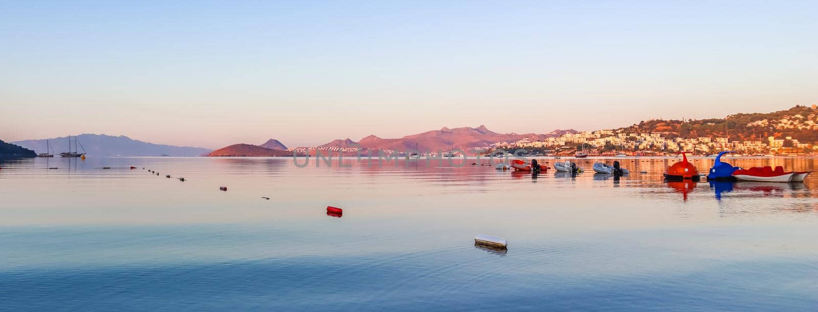 Beautiful sunrise on Mediterranean coast with islands and mountains, boats and catamarans by Olayola