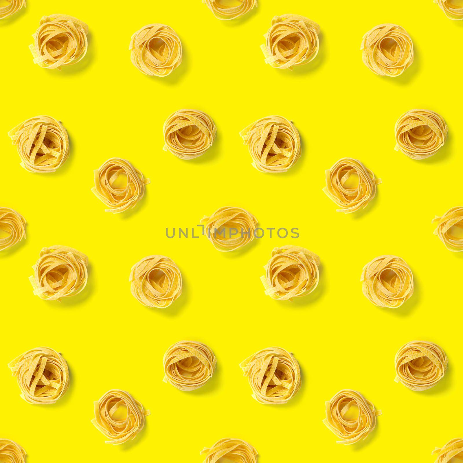 Seamless pattern from Italian pasta tagliatelle. raw pasta fettuccine pop art background, flat lay. Italian raw nest pasta isolated on yellow by PhotoTime