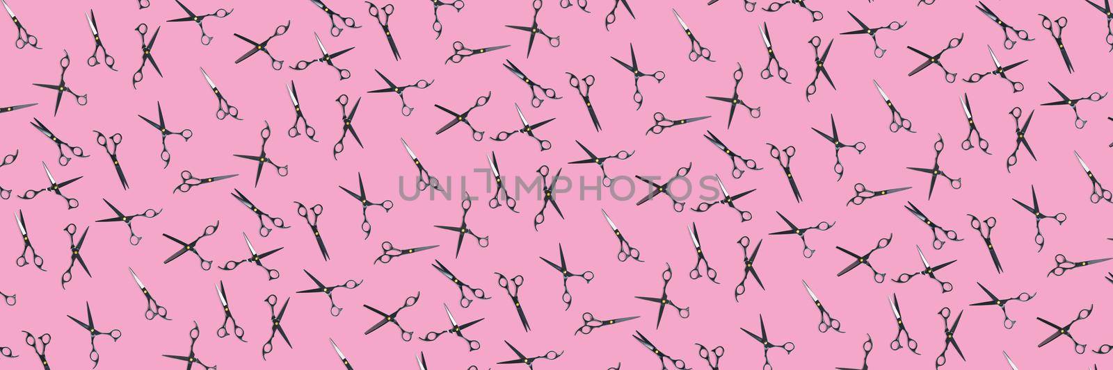 Background made from black scissors. professional hairdresser black scissors isolated on pink. Black barber scissors, close up. pop art background by PhotoTime