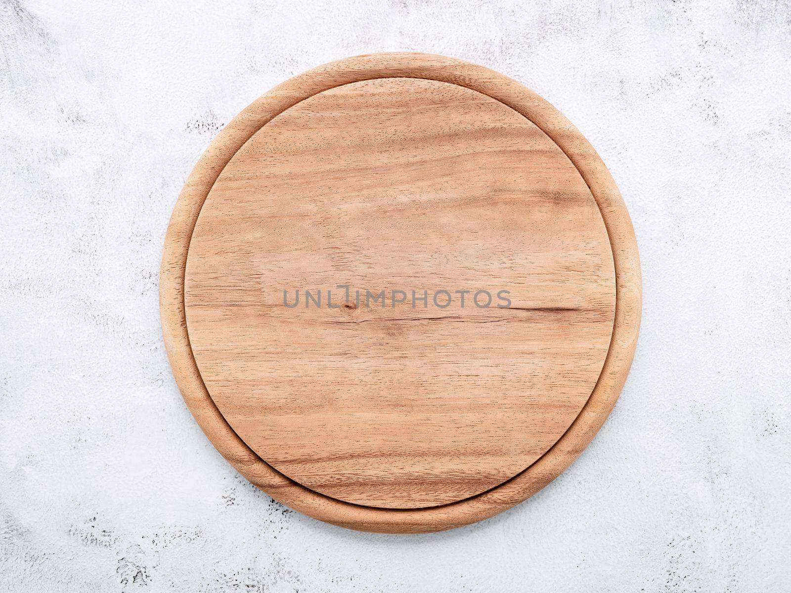Empty wooden pizza platter set up on white concrete. Pizza board on white concrete background flat lay and copy space.