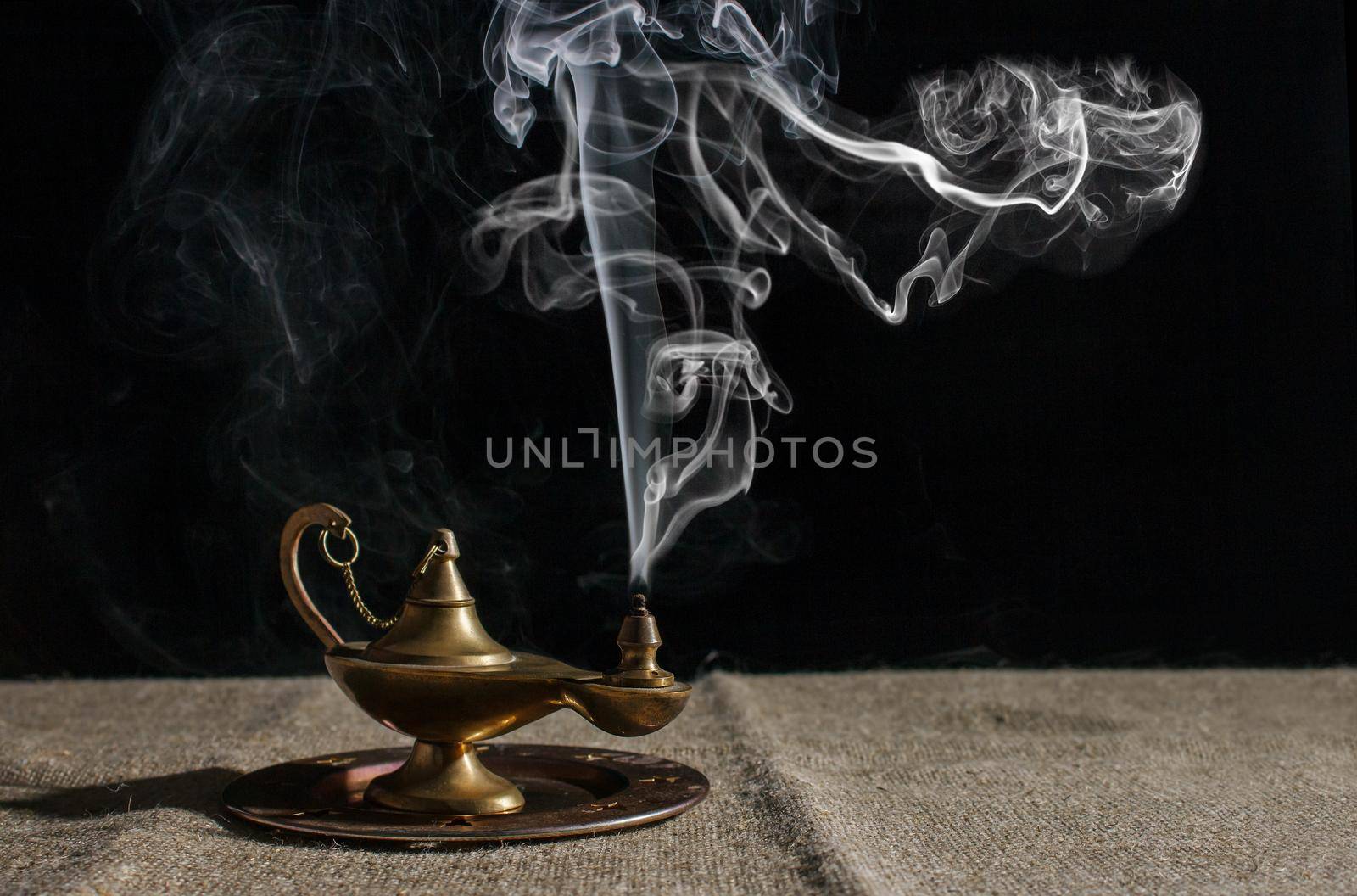 aladdin's magic lamp smokes on table by raddnatt