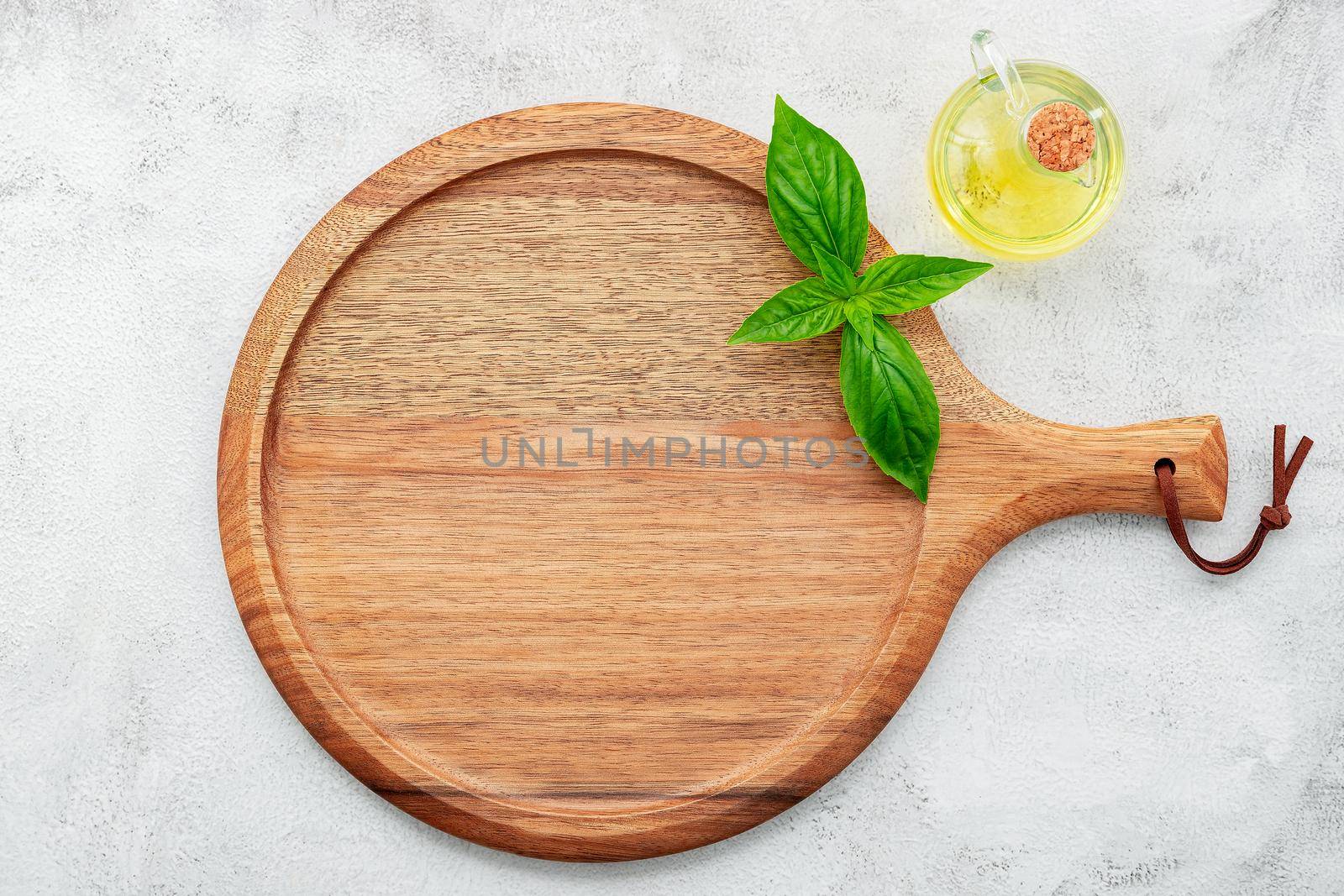 Empty wooden pizza platter set up on white concrete. Pizza tray on white concrete background flat lay and copy space.