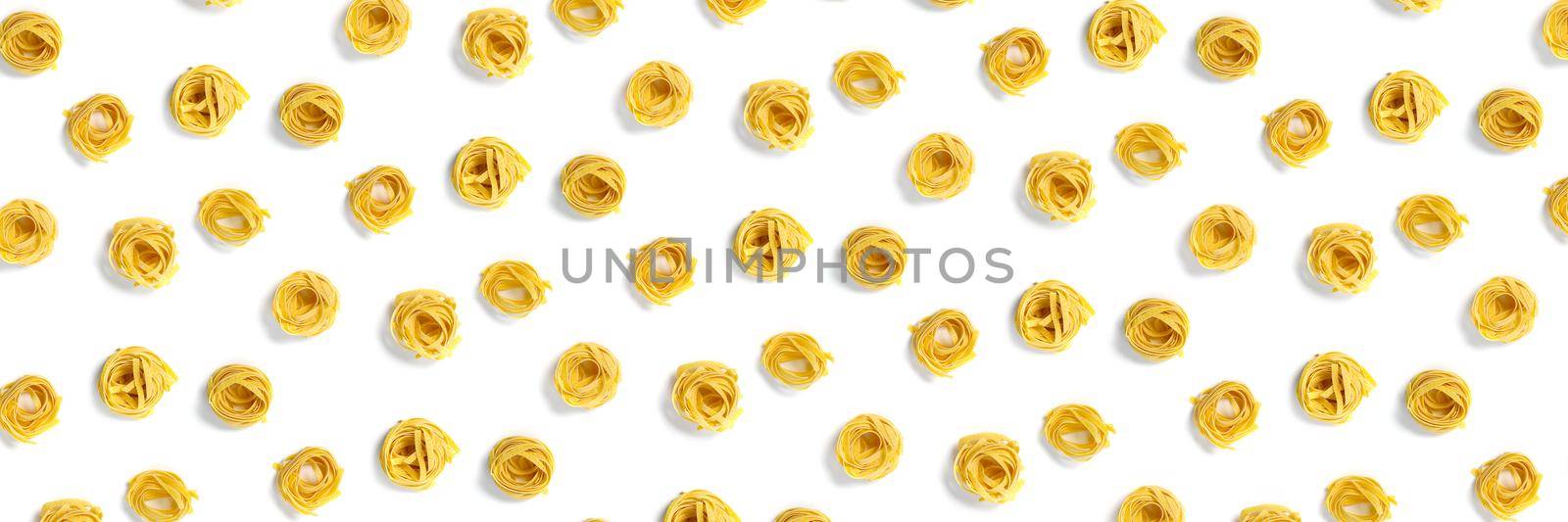 background from Italian tagliatelle pasta. raw pasta fettuccine, pop art background, flat lay. Italian raw nest pasta isolated on white. not seamless pattern