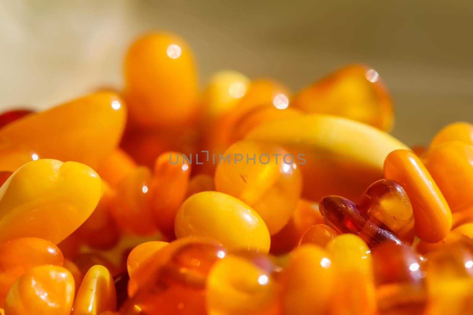 Sunny beads of fire amber. Natural gemstone background, jewelry concept by Olayola