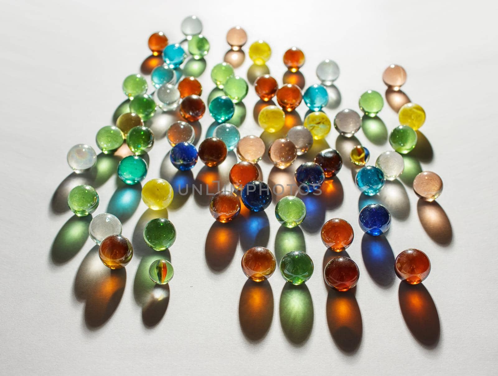 multicolored glass balls on the table by raddnatt