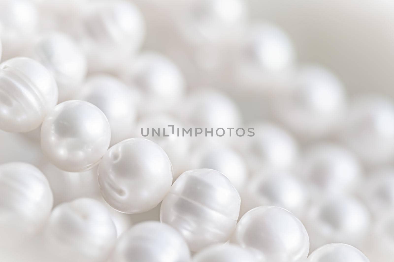 Nature white string of pearls in soft focus, with highlights.