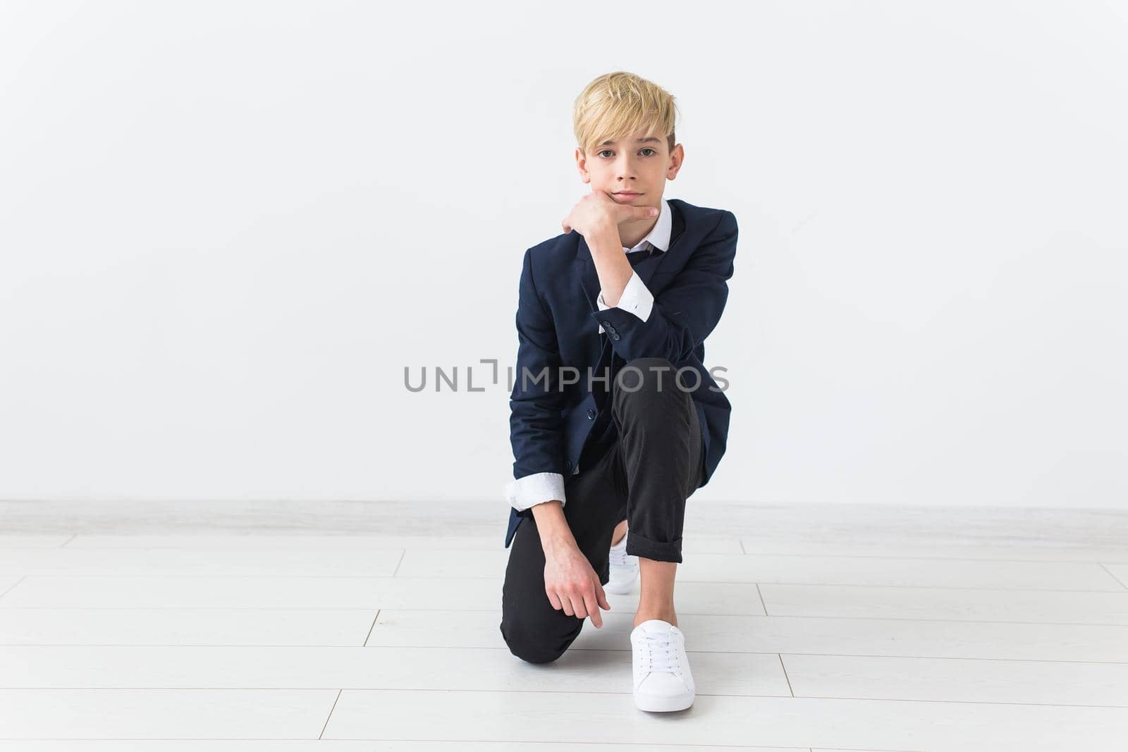 Puberty concept - Teenage boy portrait on a white background with copy space. by Satura86