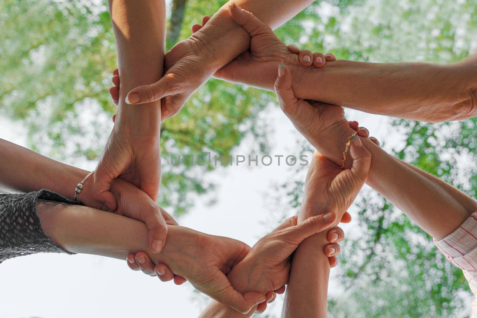 Team stacks hands in a workshop for teambuilding and teambuilding by Matiunina