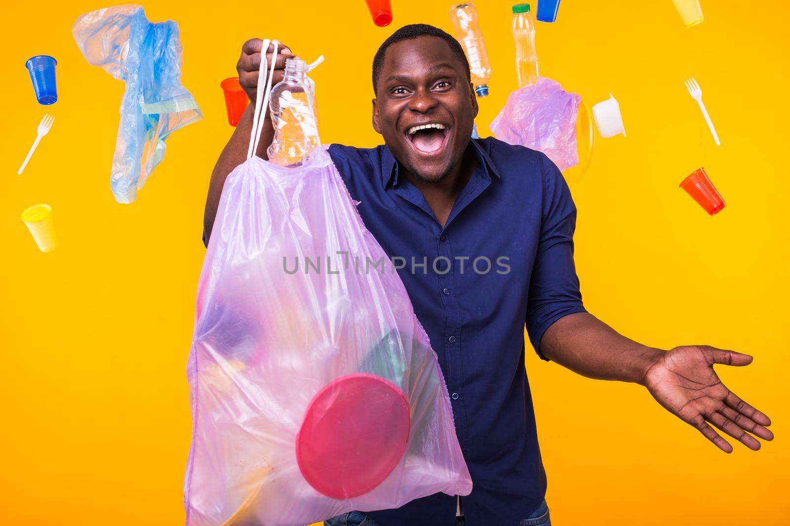 Problem of trash, plastic recycling, pollution and environmental concept - funny man carrying garbage bag on yellow background by Satura86