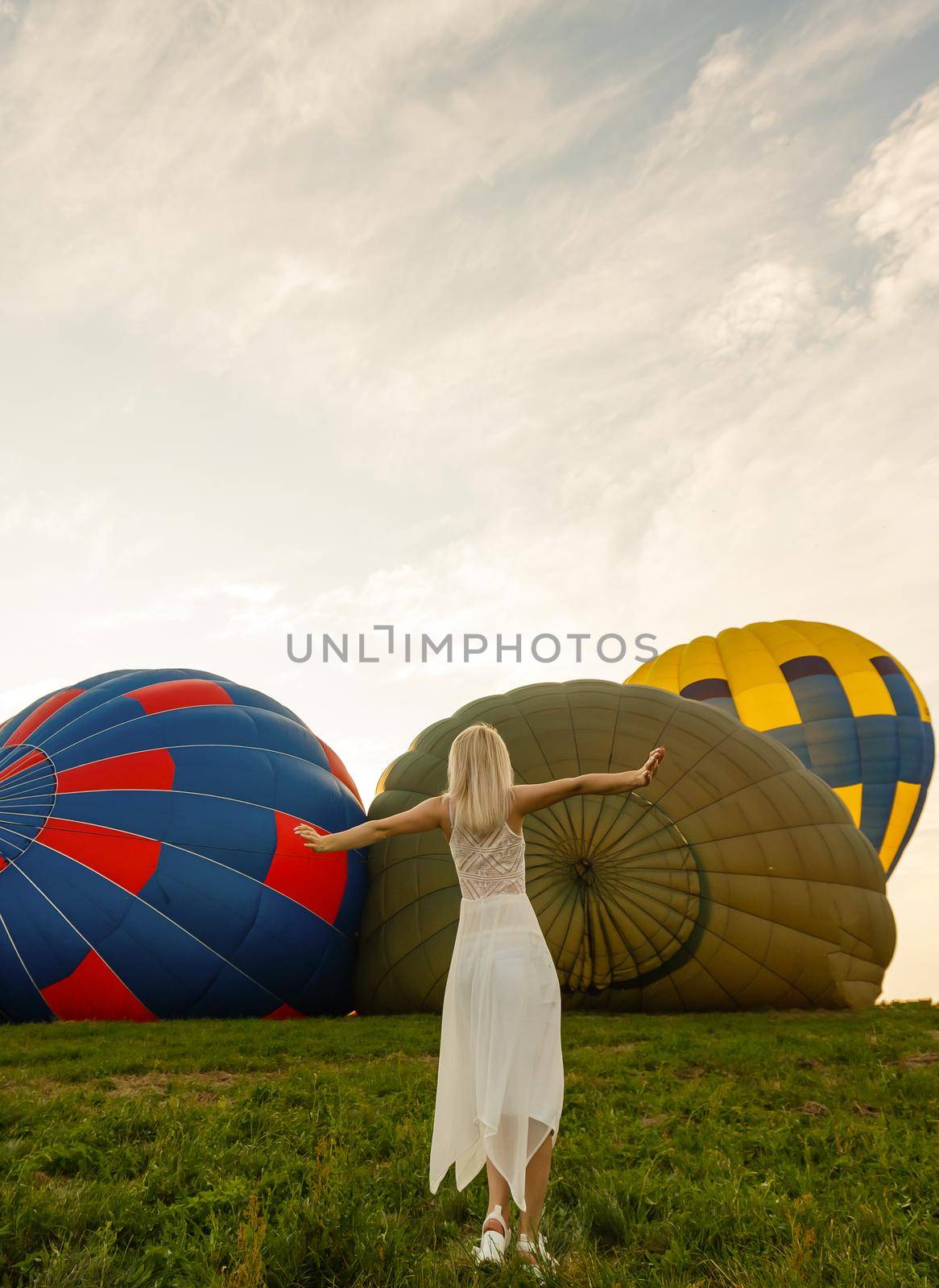 Amazing view with woman and air balloon. Artistic picture. Beauty world. The feeling of complete freedom