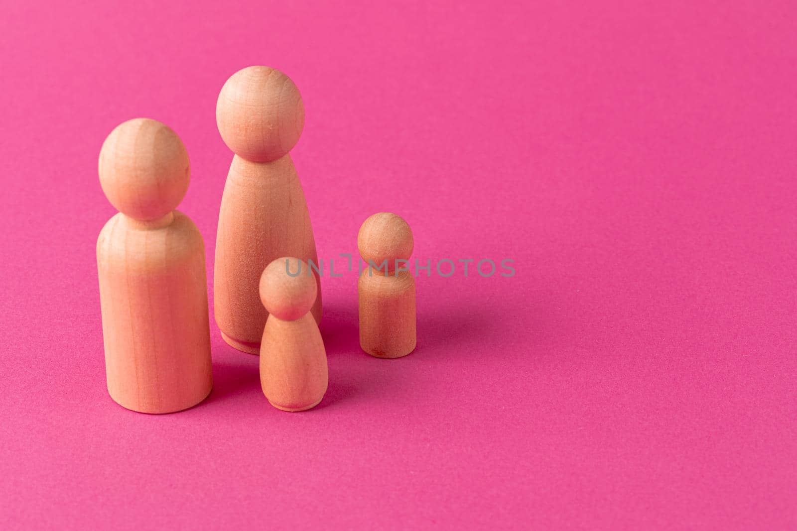 Wooden little figures of people close up. Family concept
