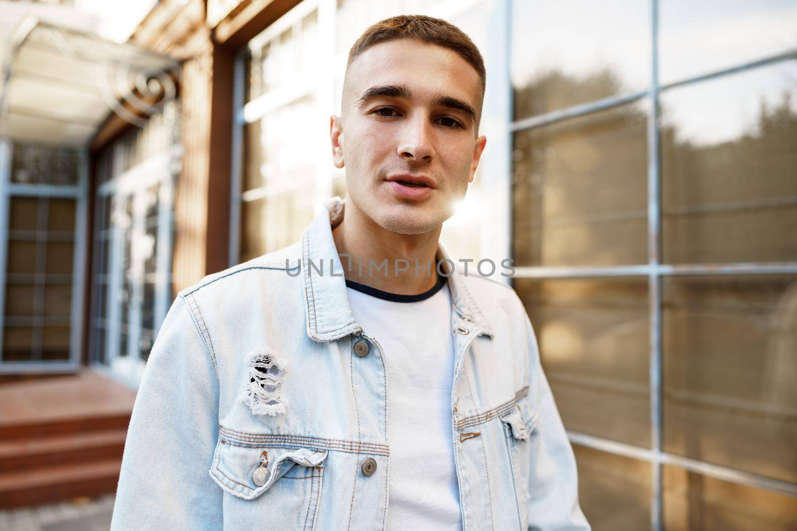 Portrait of handsome young casual man walking on the city street