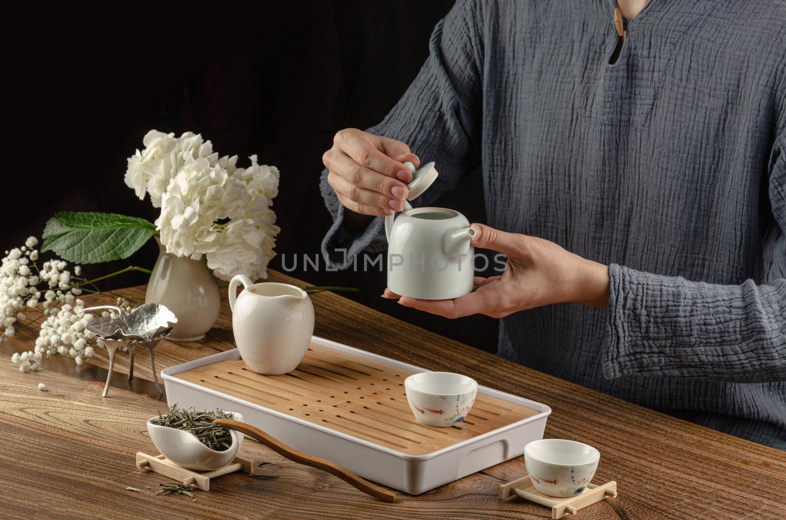 tea table with instruments teapots cups and green tea cooking process