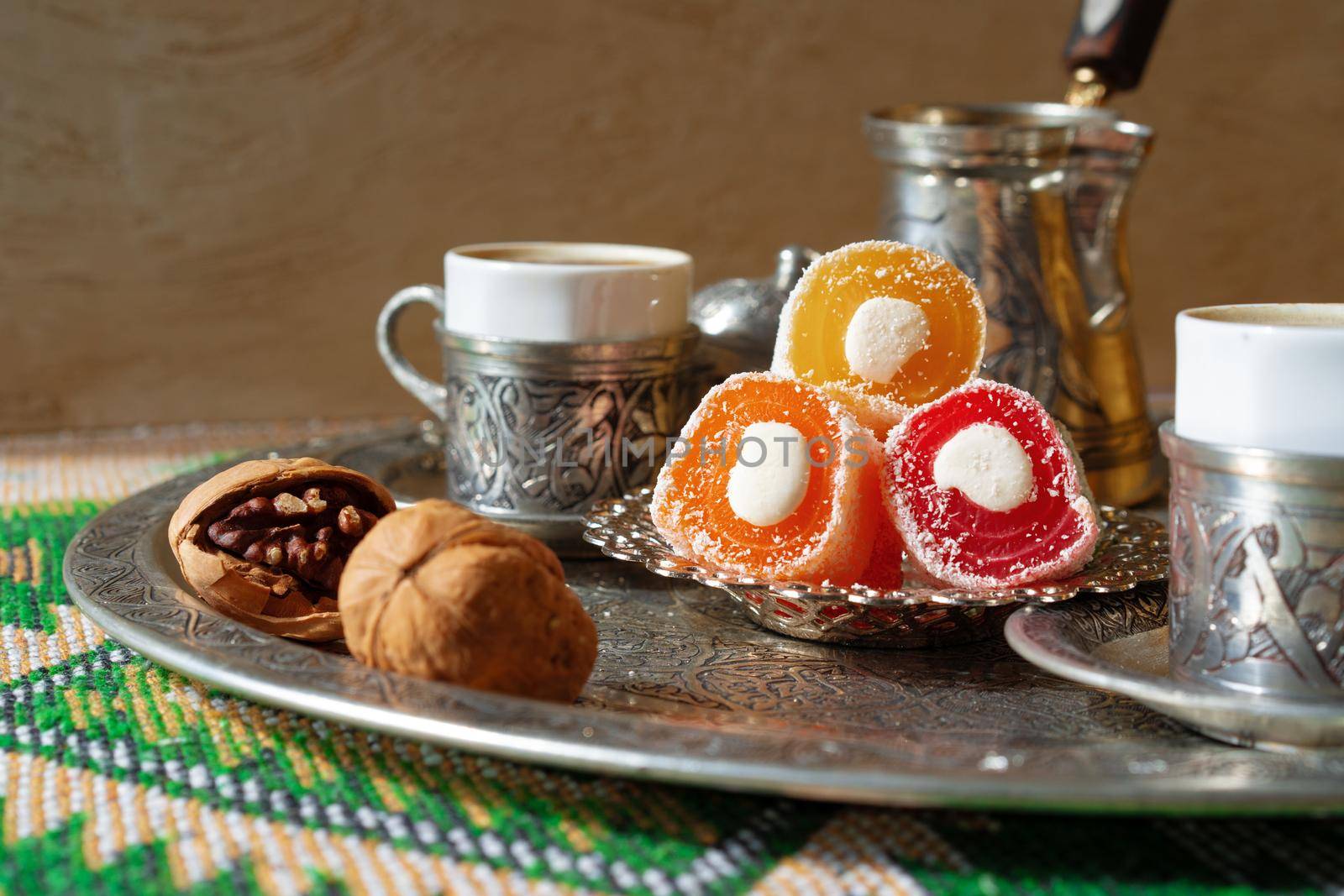 Turkish Coffee served with Turkish Delight on metal tray, close up