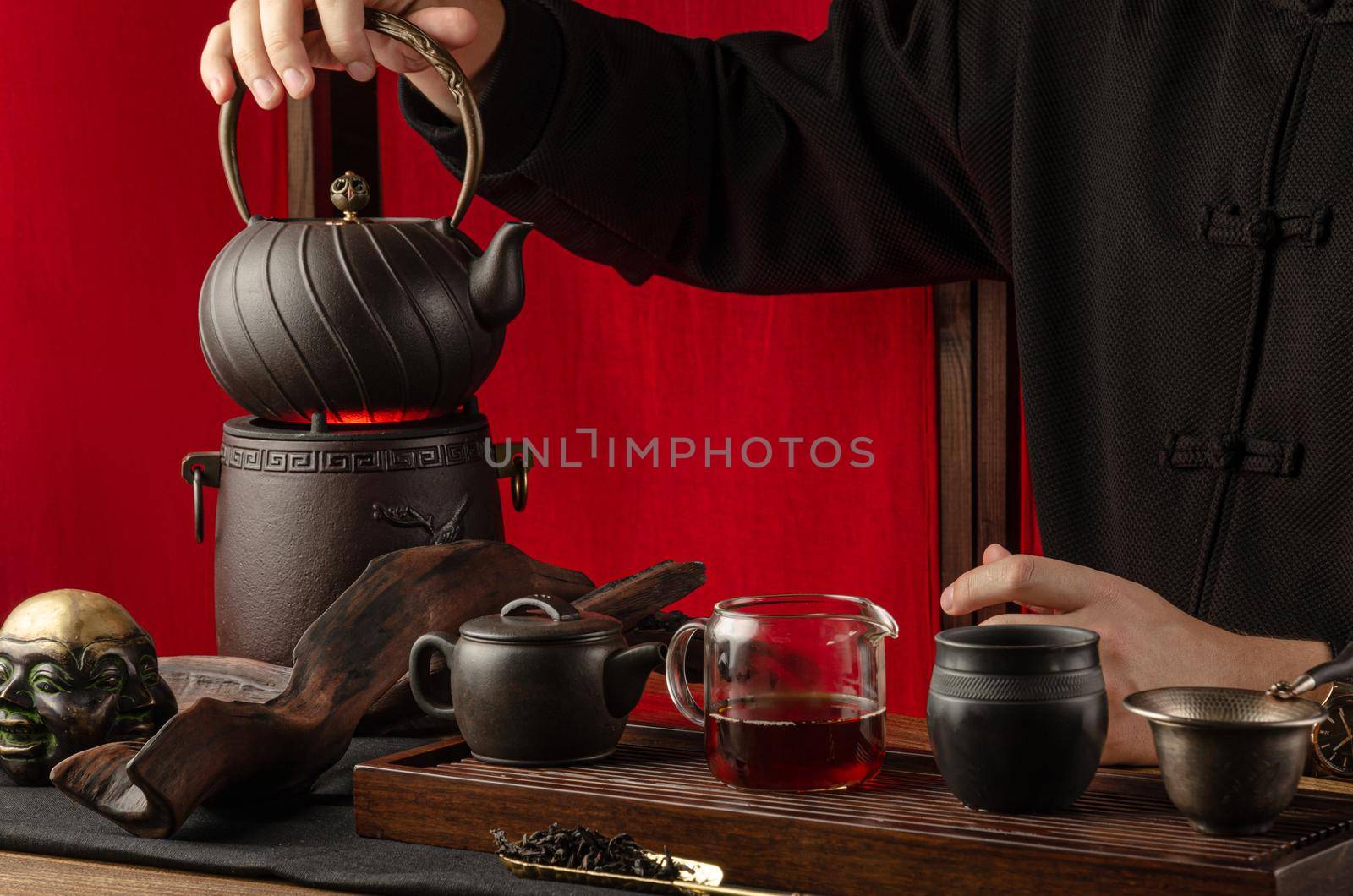 the tea table with instruments teapots cups pancake and tea Shen Puer