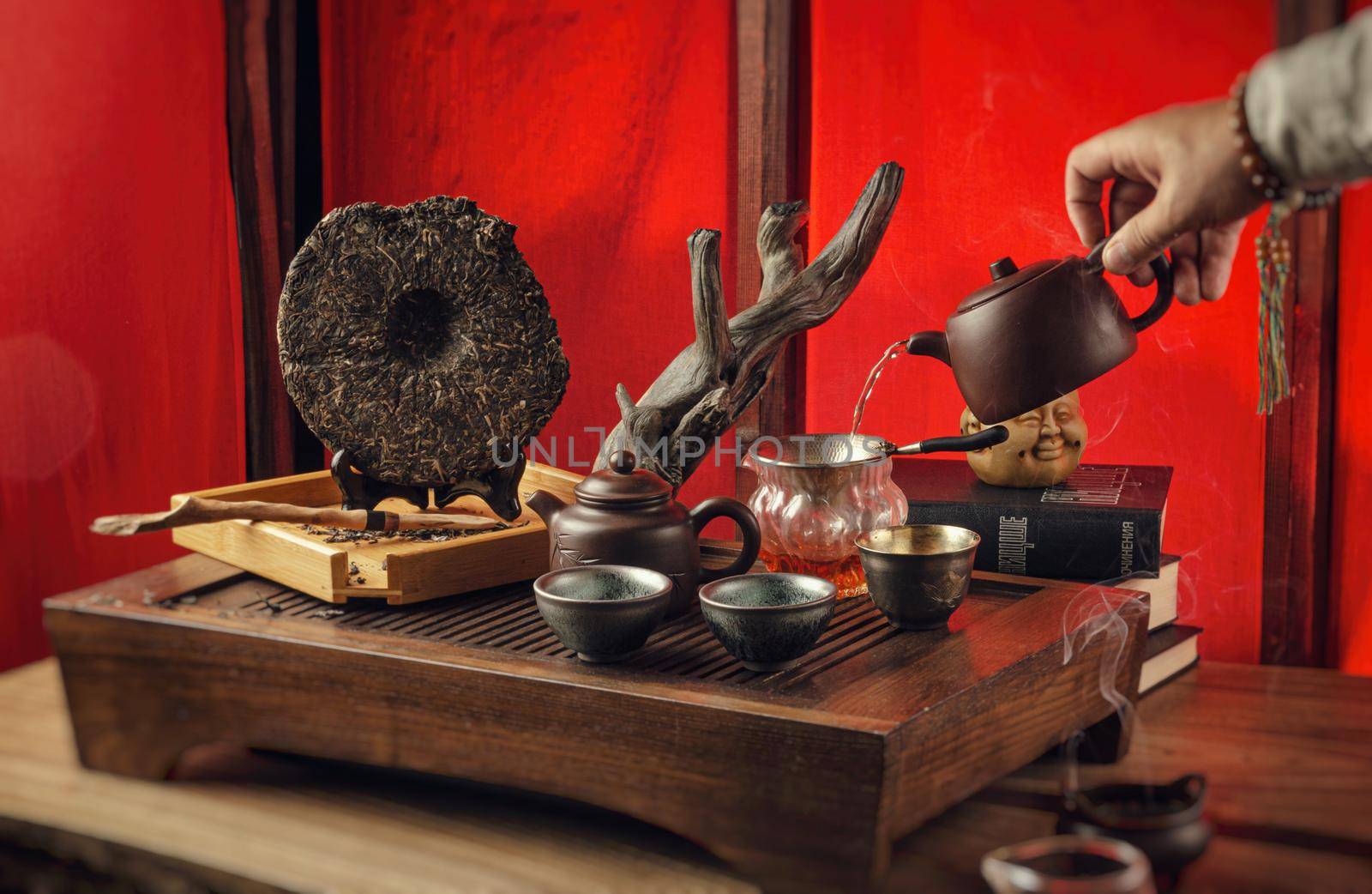 tea table with instruments teapots cups pancake and tea Shen Puer