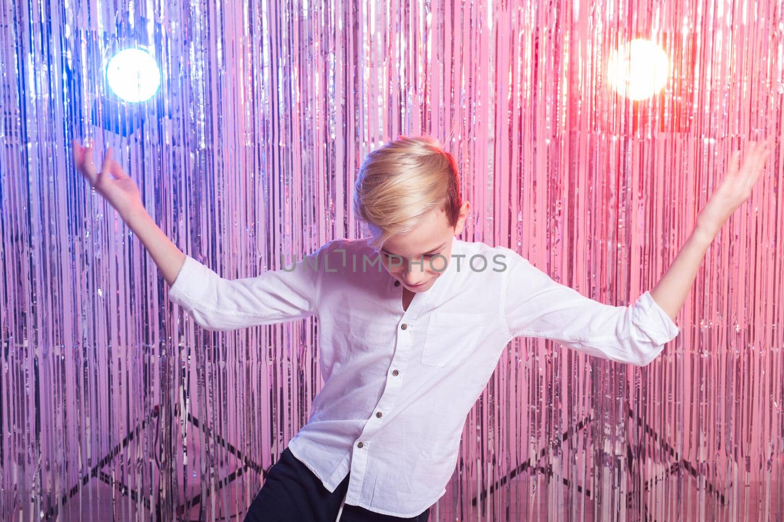Teen boy dancing hip-hop on shiny background. Dance and child concept. by Satura86