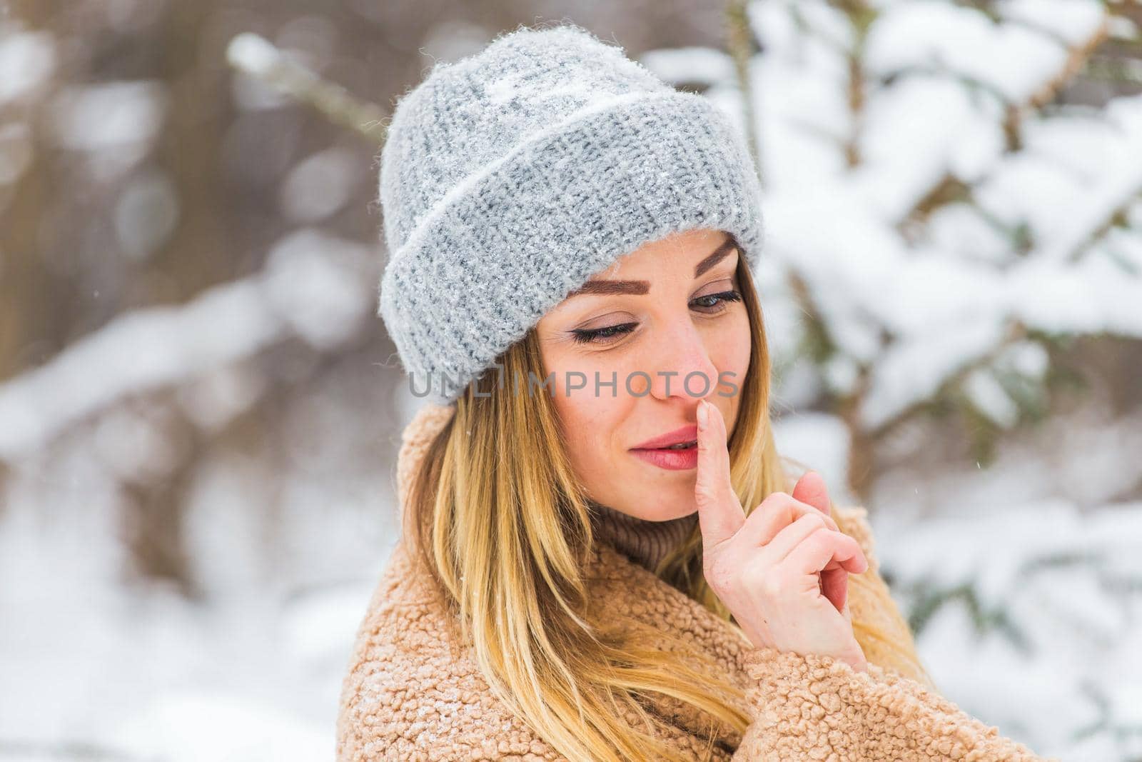 Attractive young woman in winter time outdoor. Snow, holidays and season.