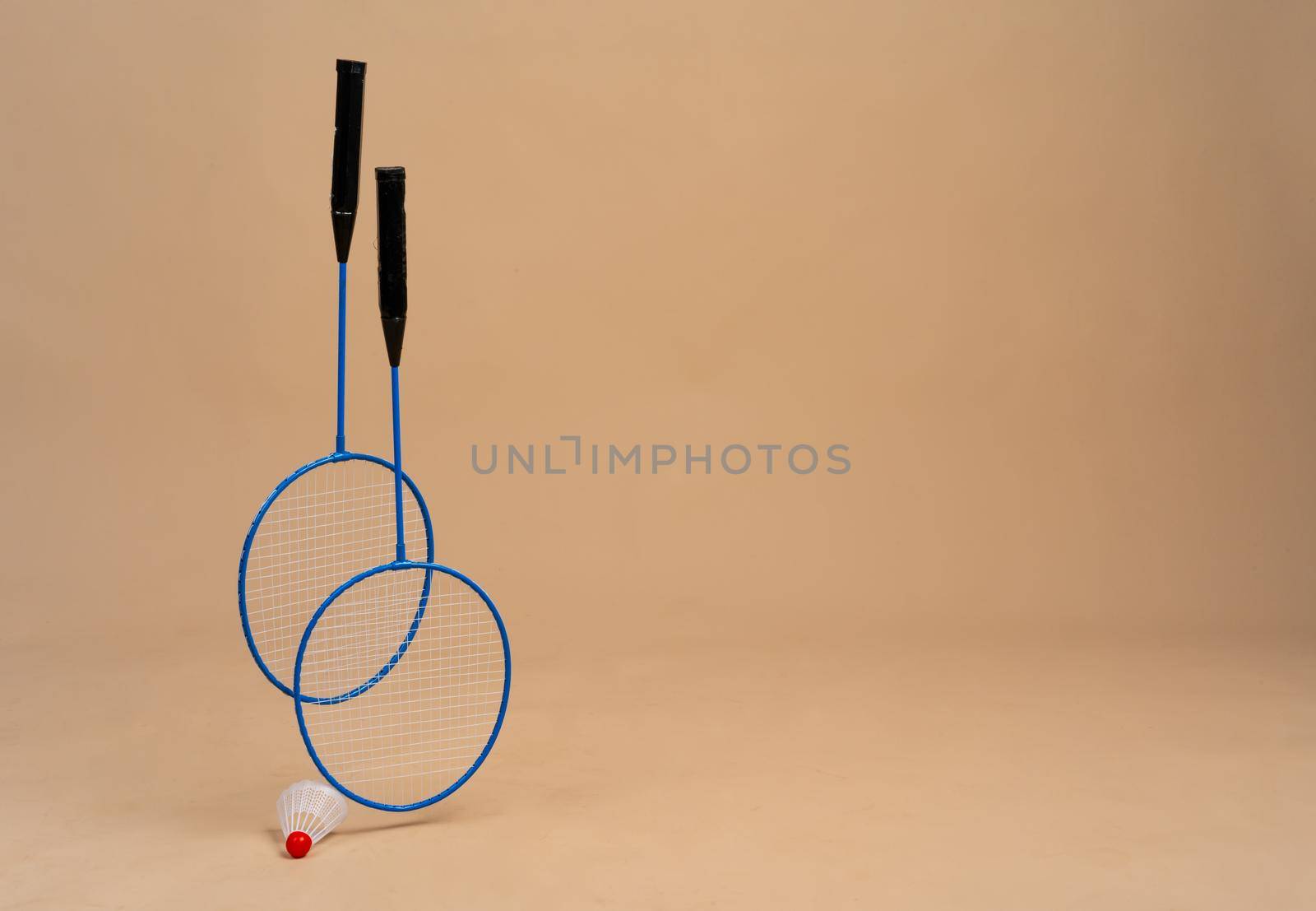 Set of shuttlecock and two badminton rackets. Close up.