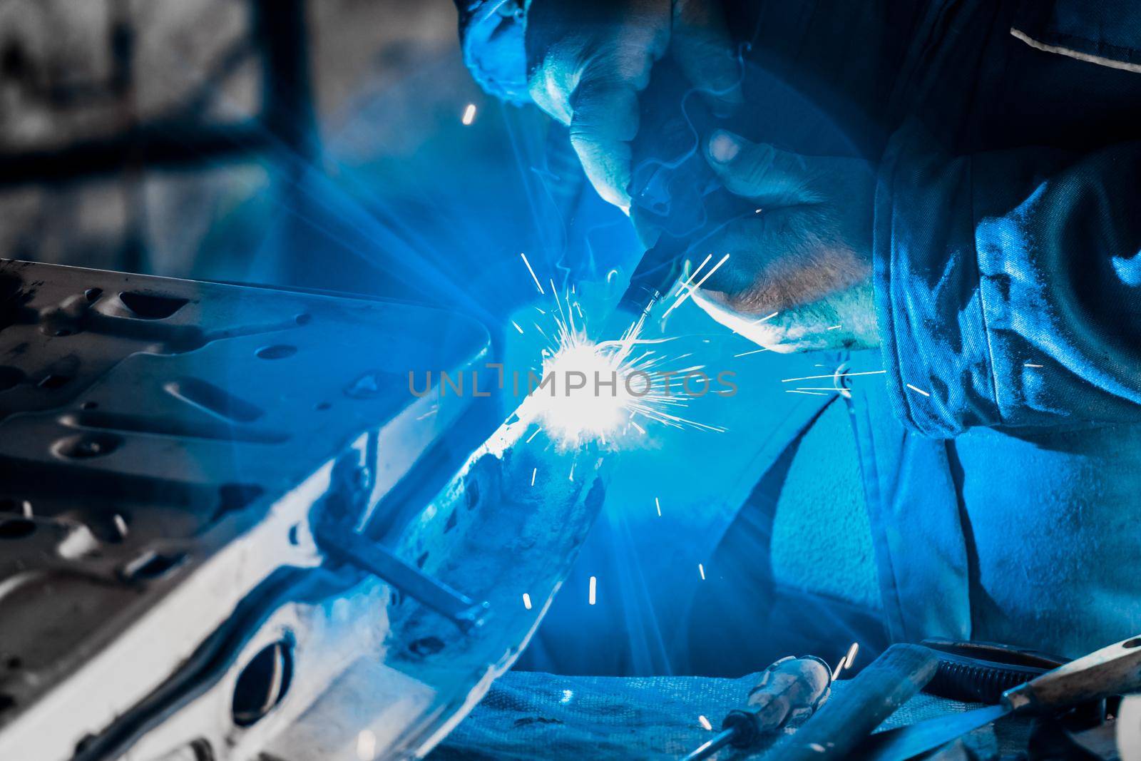 Close-up of welding and metal works of a male welder worker at the plant.