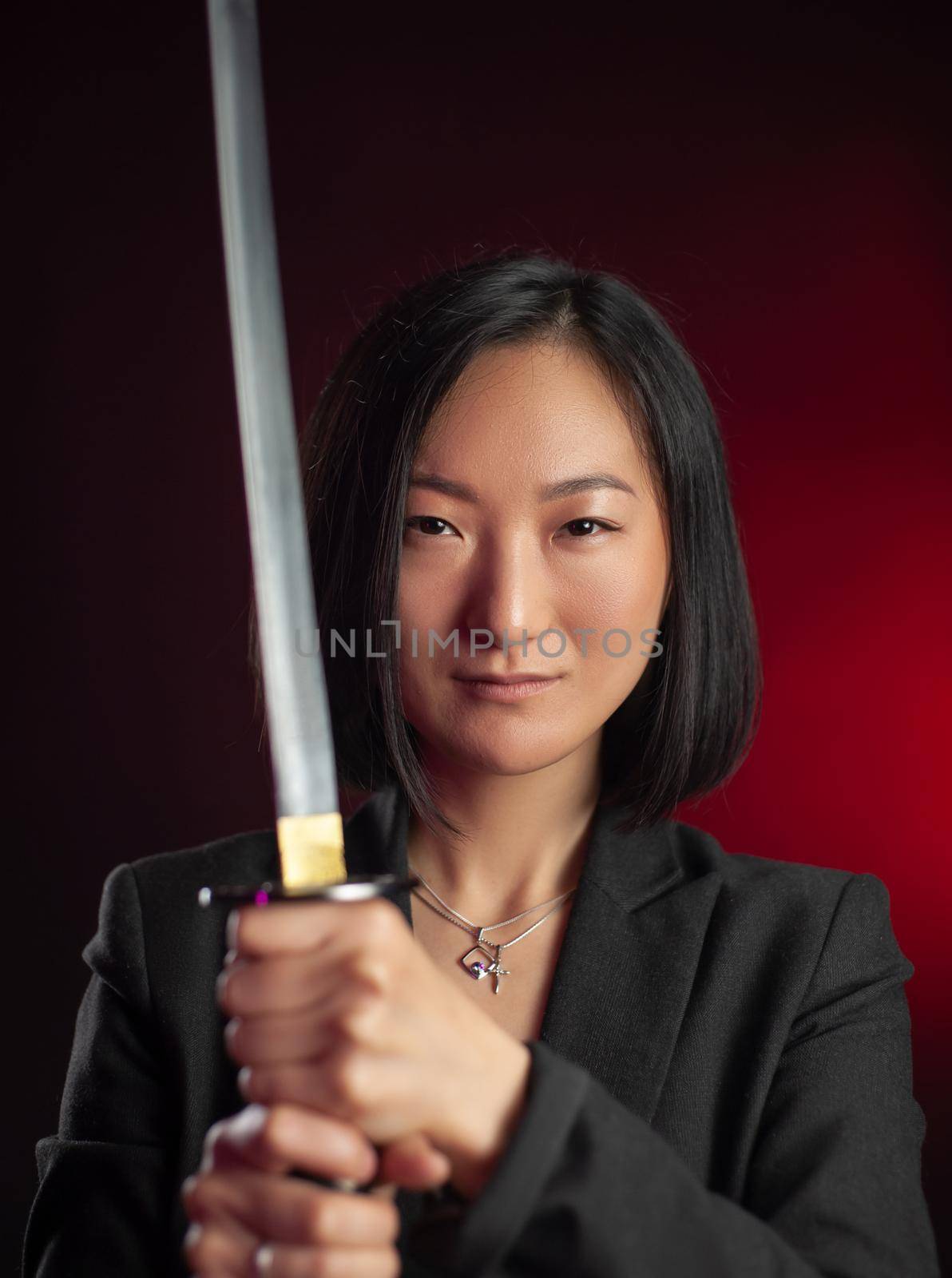 the asian woman in a jacket with a katana in her hands mafia fighter emotions on her face