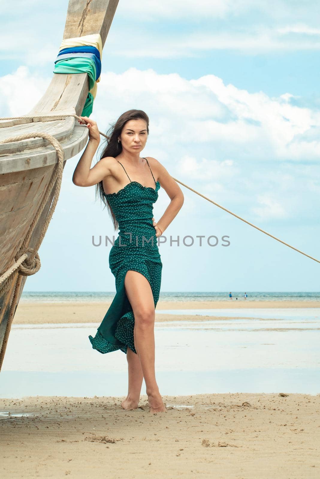 photo of a charming brunette long-haired woman on the ocean. Fashion and glam concept. Copy space by Rotozey