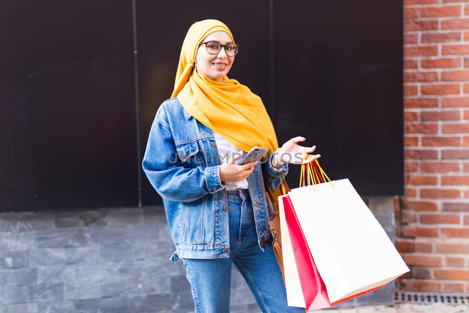 Sale and buying concept - Happy arab muslim girl with shopping bags after mall by Satura86