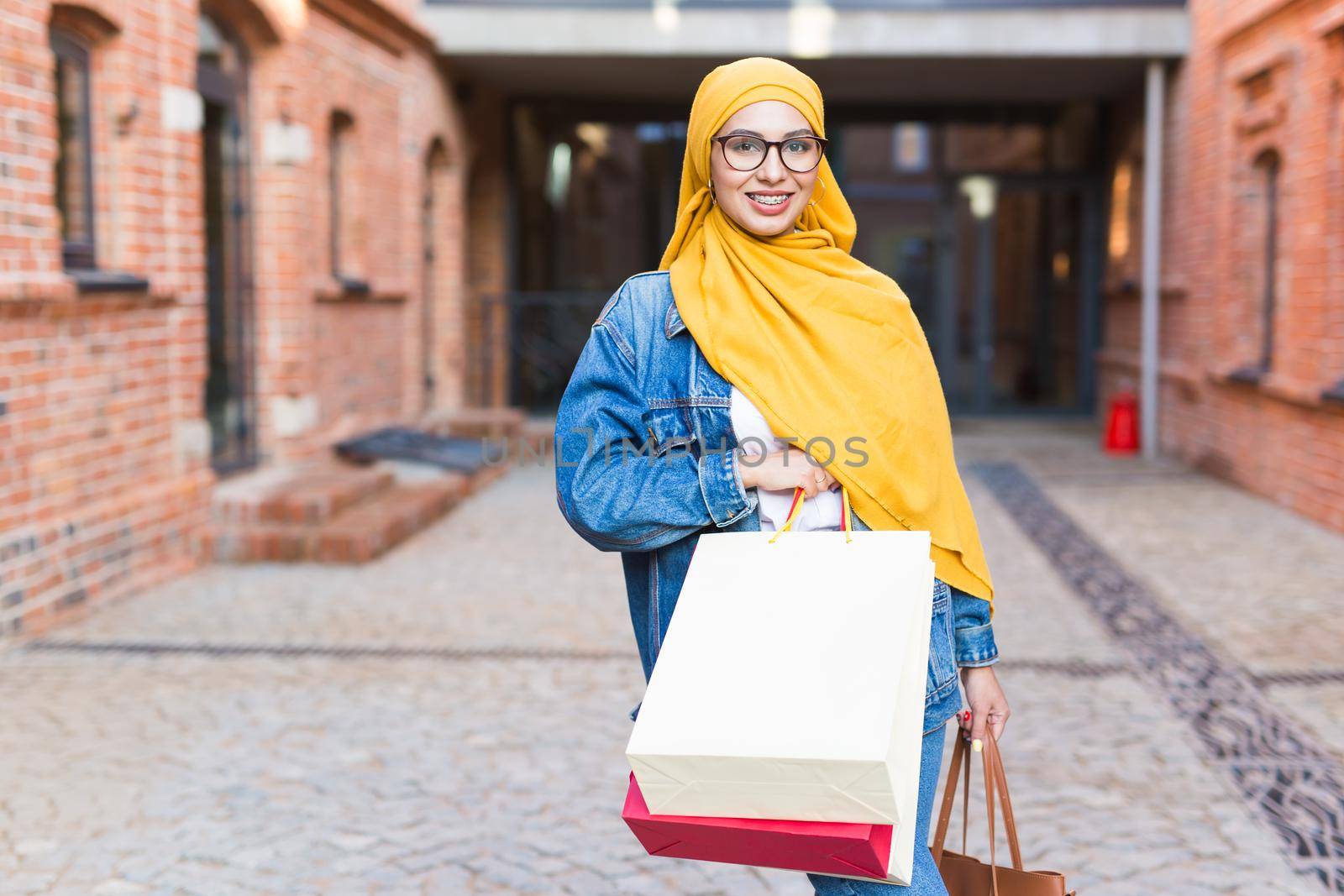 Happy arab muslim girl with shopping bags after mall