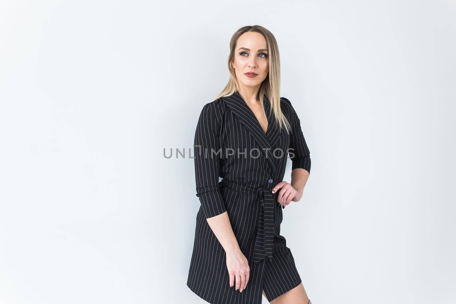 Fashion concept - Portrait of sexy business woman in a suit on white background with copy space. by Satura86