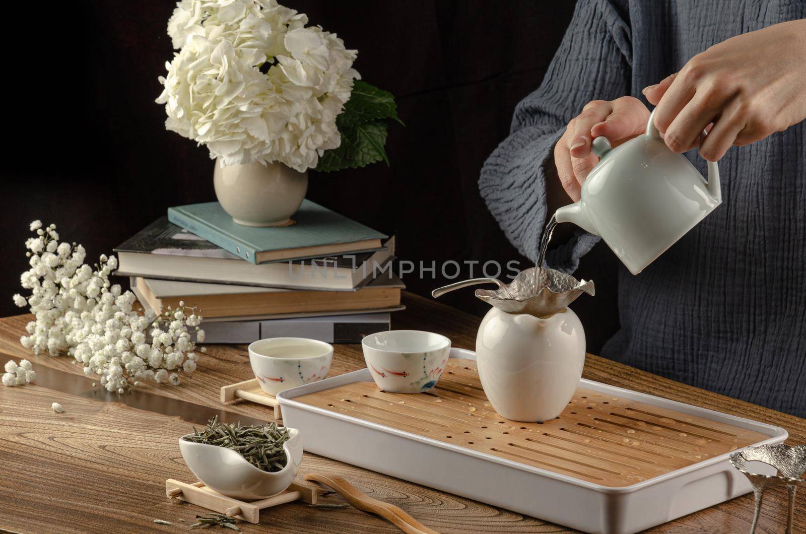 tea table with instruments teapots cups and green tea cooking process