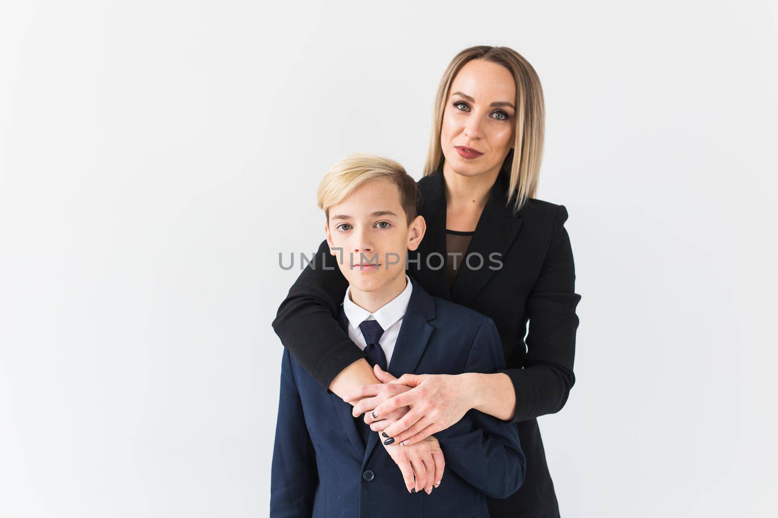 Parenting, family and single parent concept - A happy mother and teen son smiling on white.