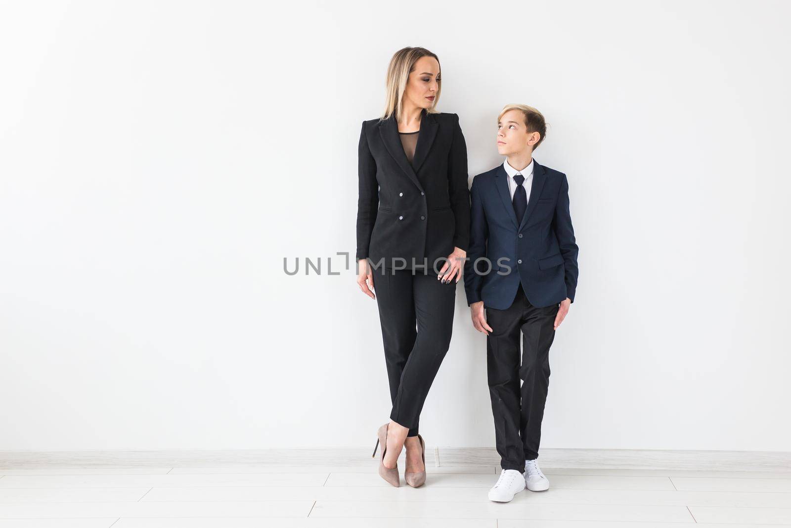 Parenting, family and single parent concept - A happy mother and teen son smiling on white.