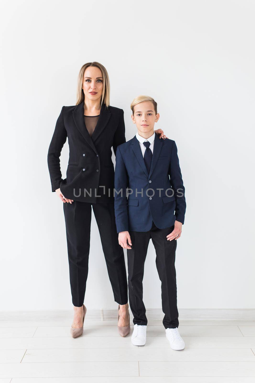 Parenting, family and single parent concept - A happy mother and teen son smiling on white.