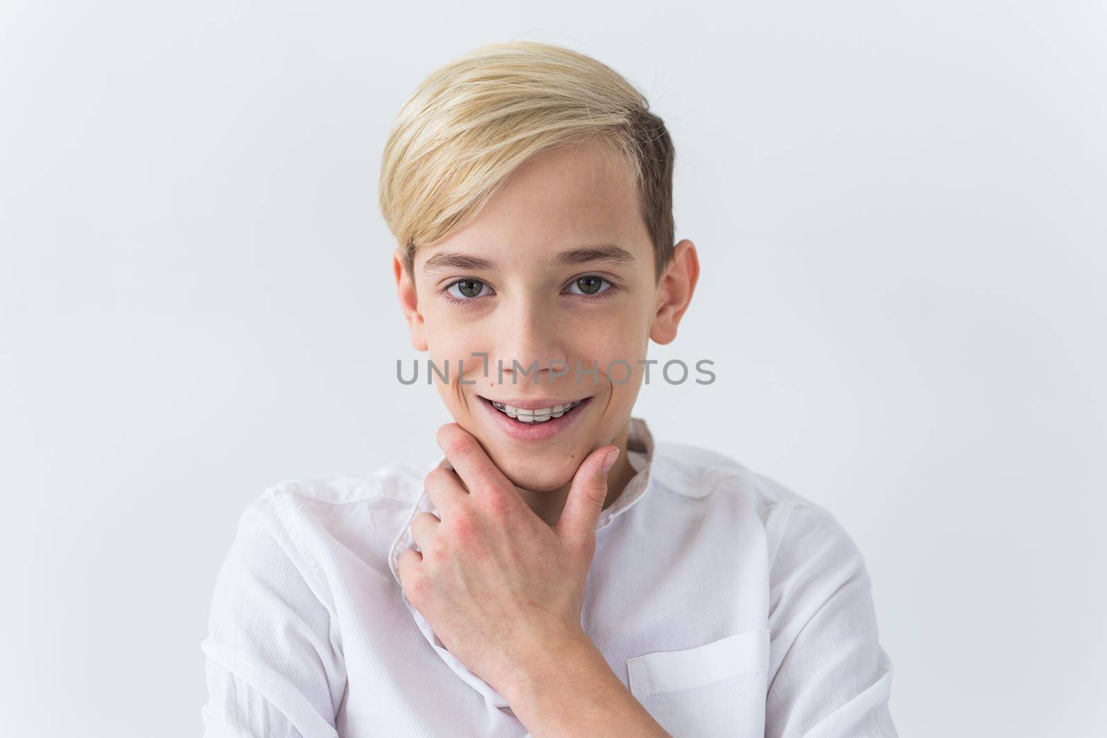 Attractive eleven year old boy with braces on his teeth. Dentistry and teenager concept. by Satura86