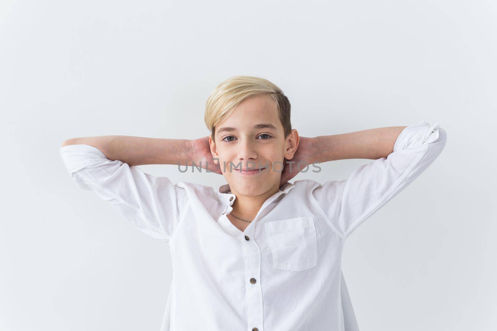 Solitude, loneliness and boredom concept - Bored teen student sitting in a school chair isolated on white background by Satura86