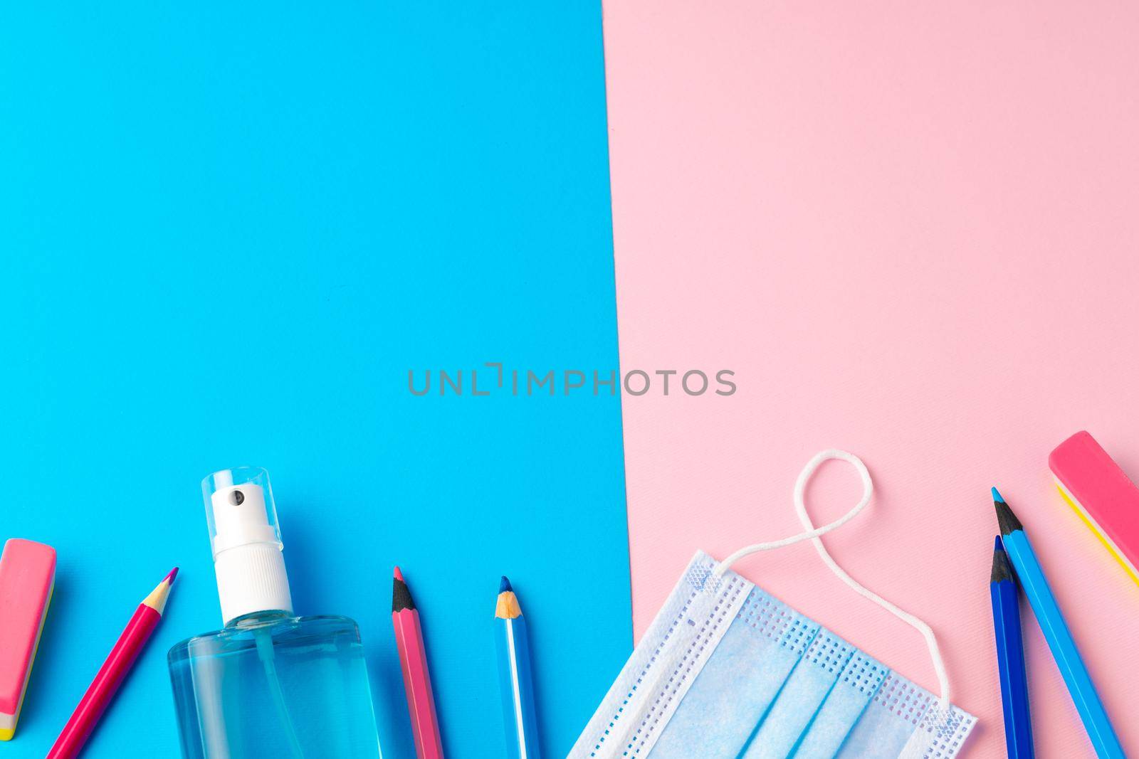 School stationery items and medical face mask, top view
