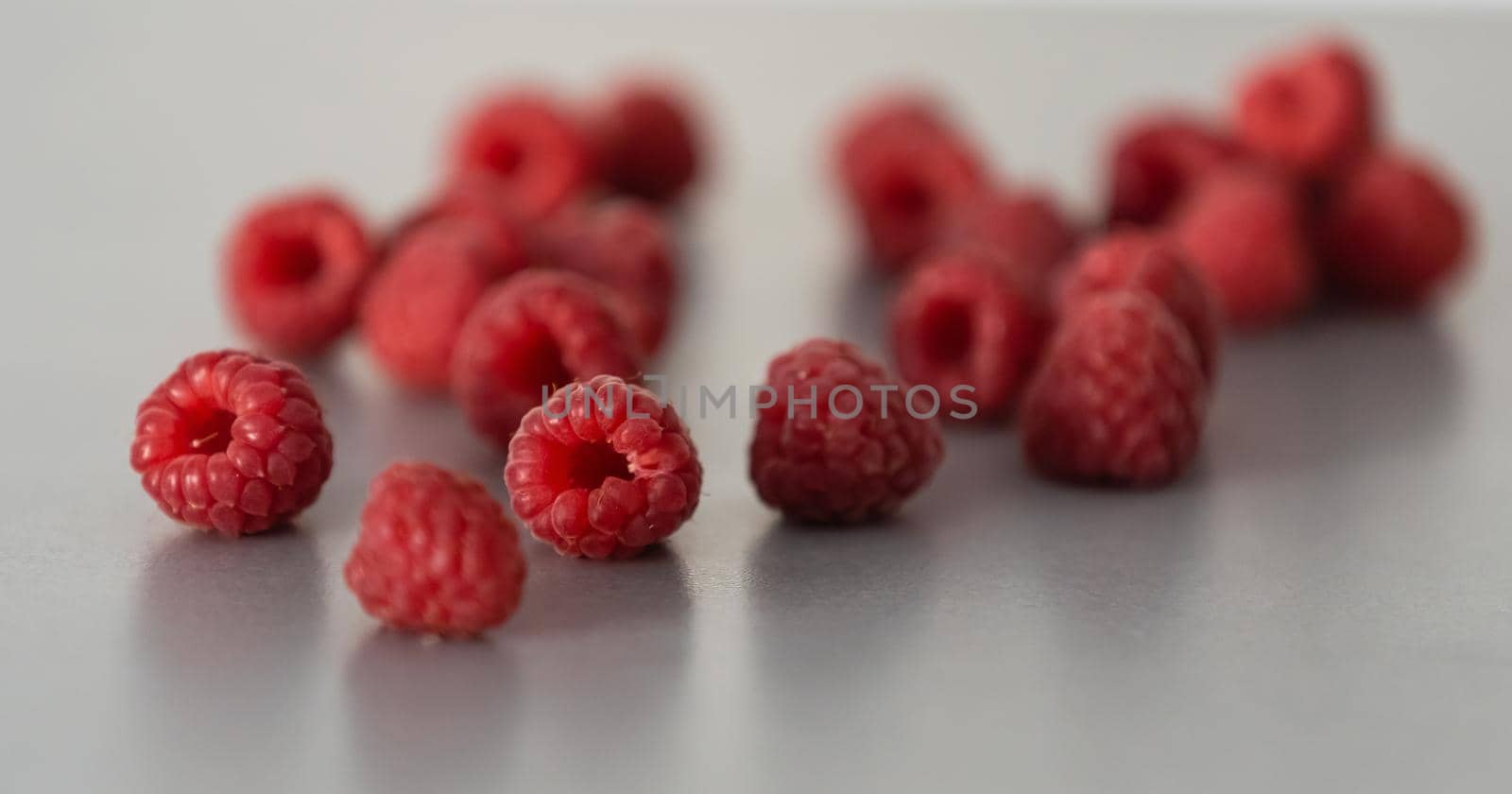 red Raspberry fruit on gray background chocolate