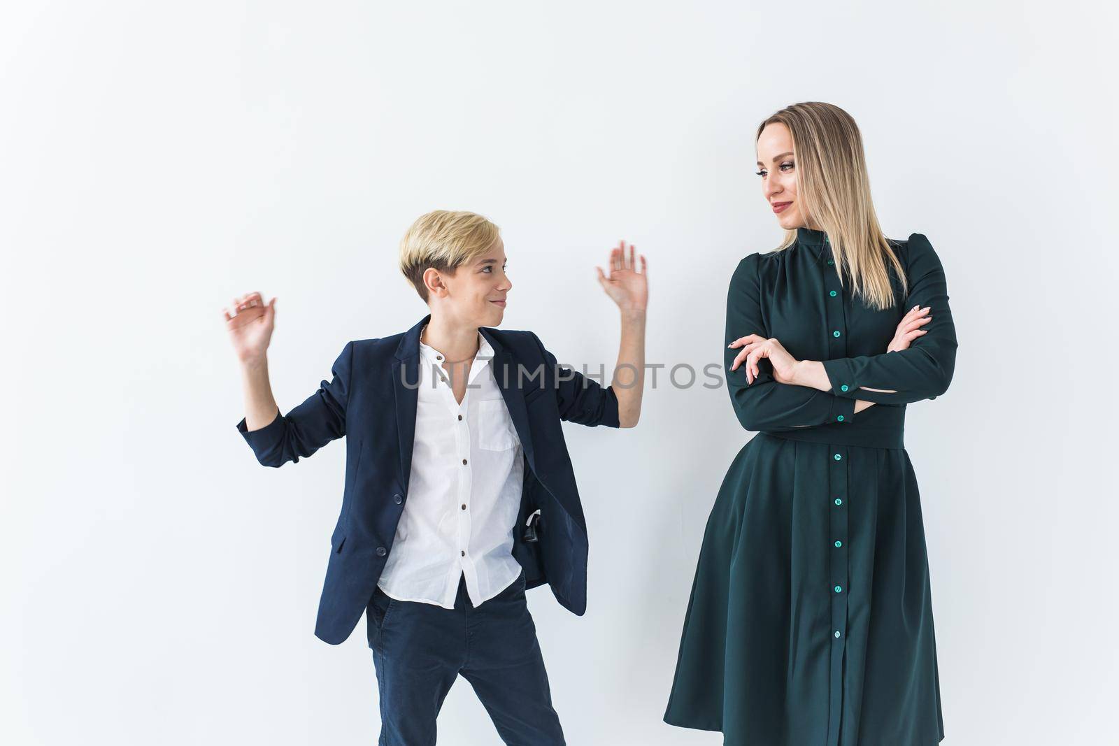 Parenting, family and single parent concept - A happy mother and teen son dancing on white background. by Satura86
