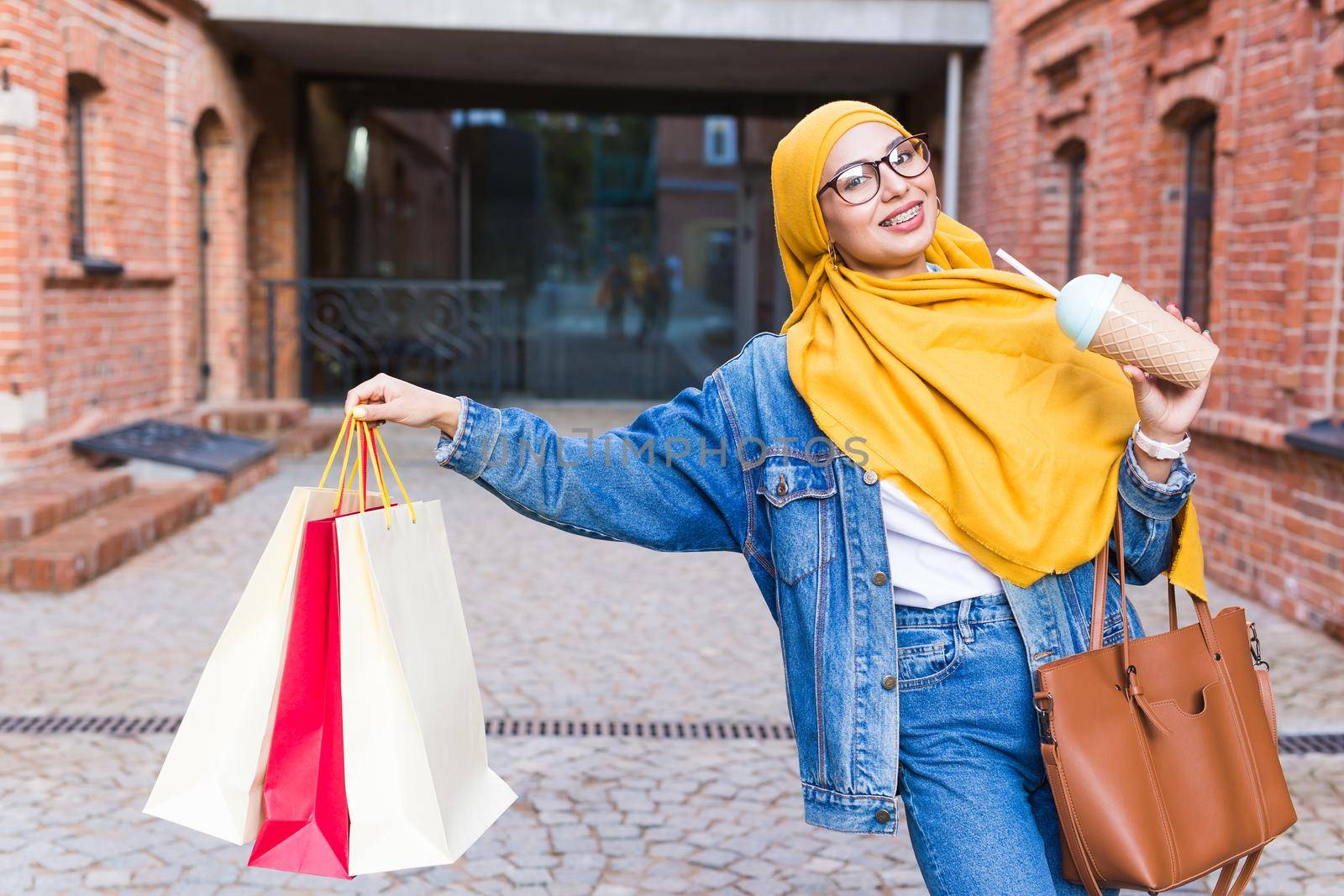 Happy arab muslim girl with shopping bags after mall