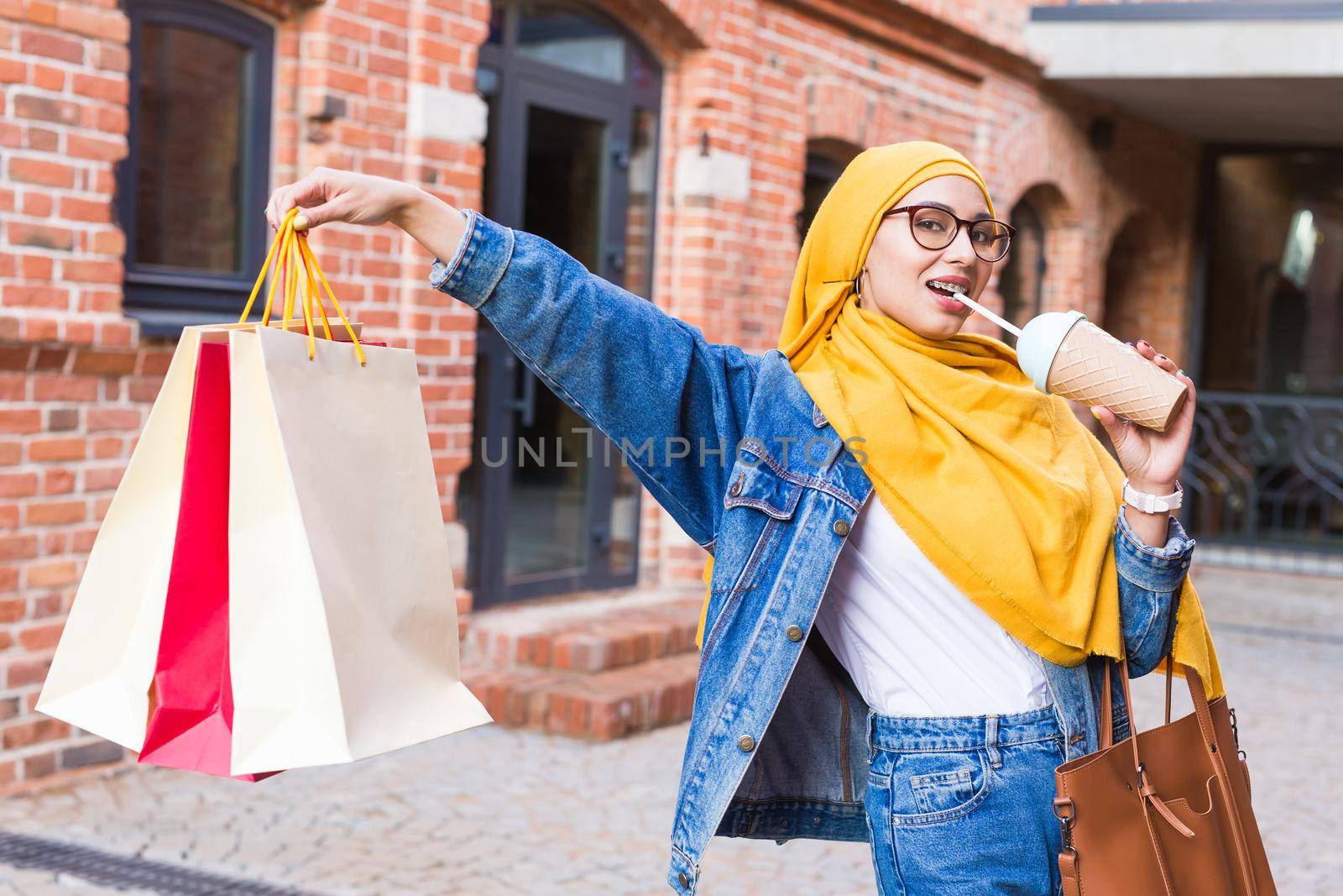 Sale and buying concept - Pretty arab muslim girl with shopping bags after mall by Satura86