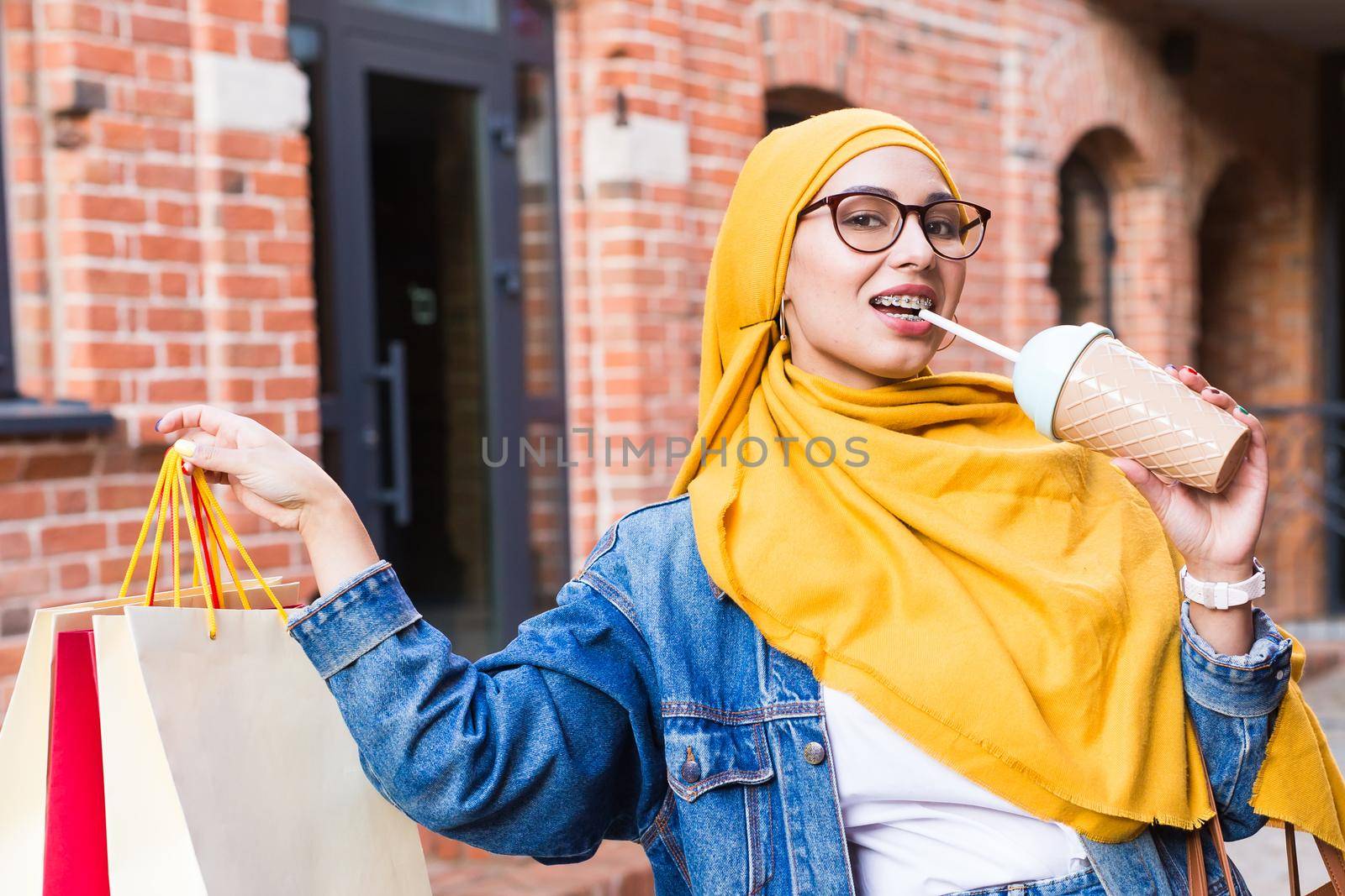 Sale and buying concept - Pretty arab muslim girl with shopping bags after mall by Satura86