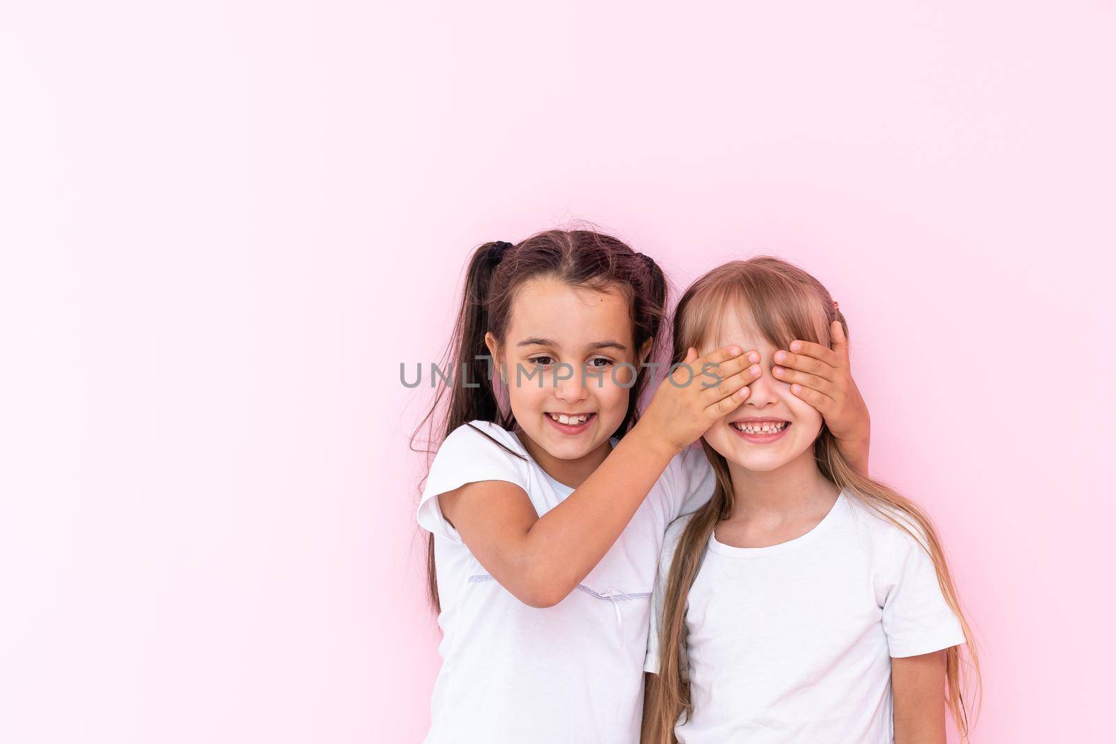 two little girls closing eyes making surprise, excited child by Andelov13