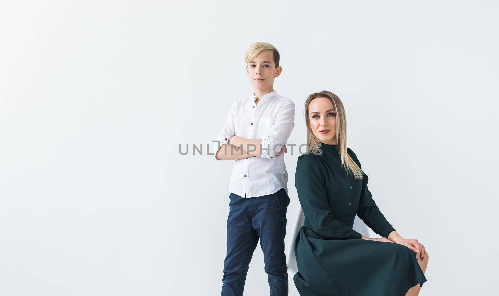 Teenager and single parent - Young mother and son together on white background. by Satura86