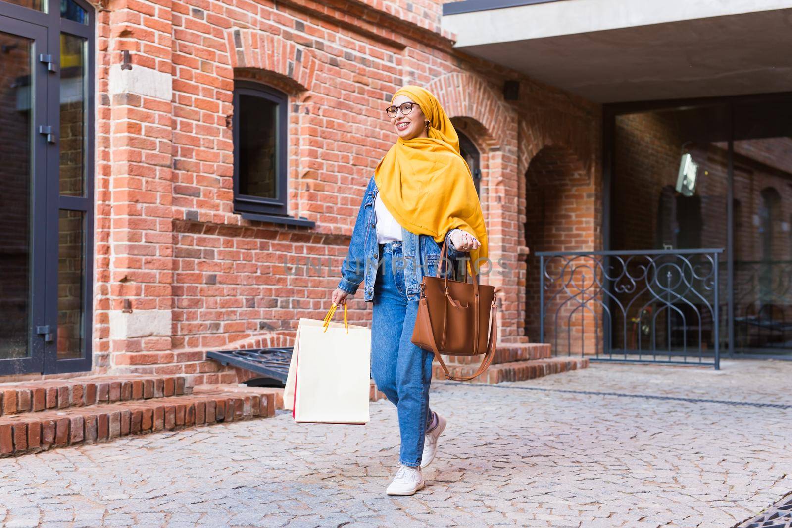 Sale and buying concept - Happy arab muslim girl with shopping bags after mall by Satura86