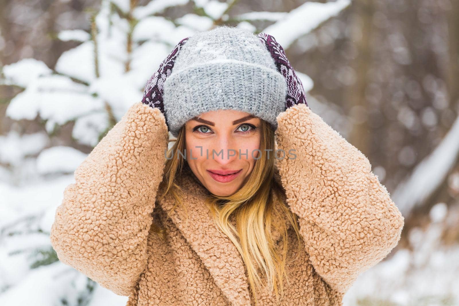 Attractive young woman in winter time outdoor. Snow, holidays and season.