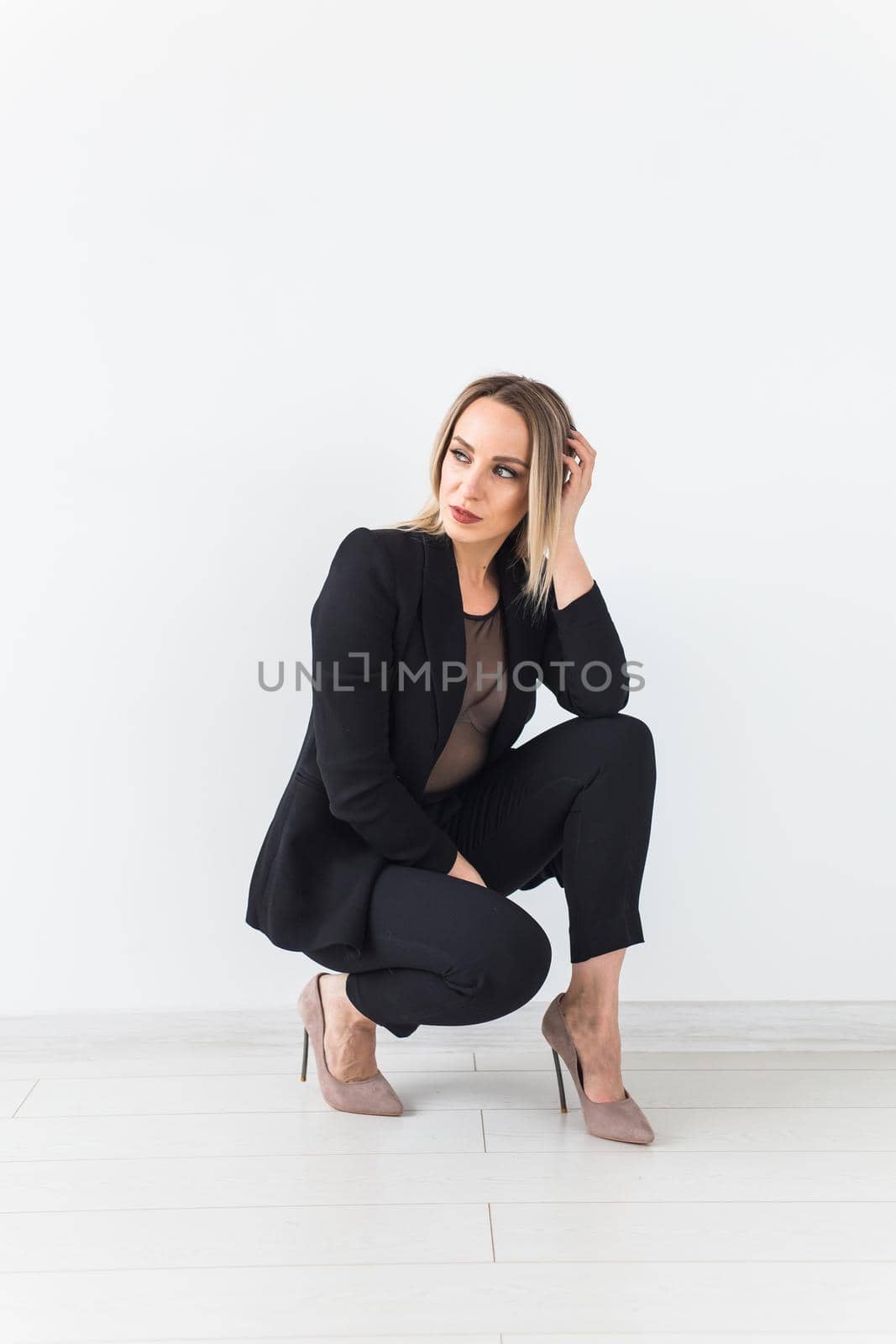 Fashion concept - Portrait of sexy business woman in a suit on white background. by Satura86