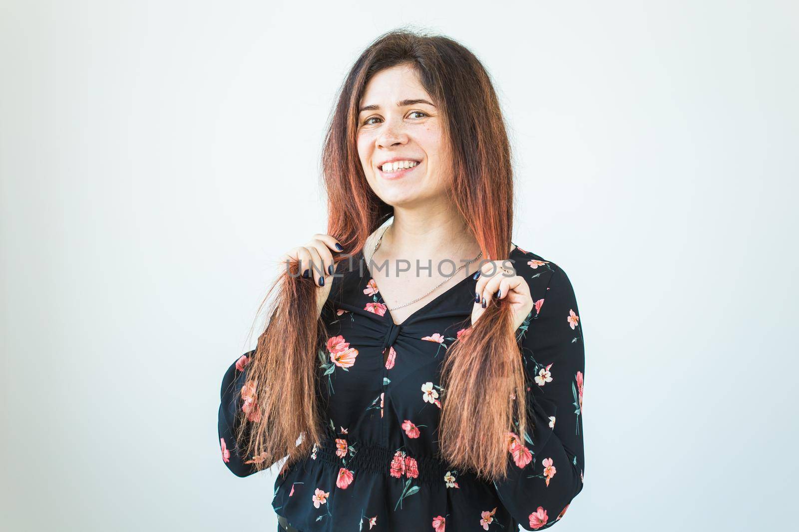 Playful and happy funny redhead woman having fun laughing on a white.