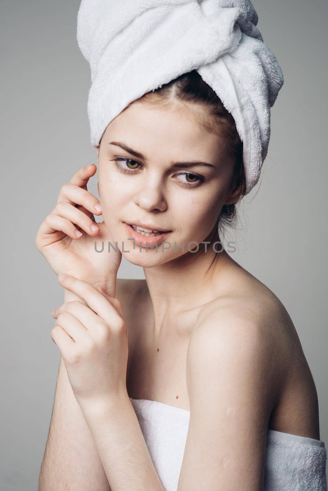 woman after shower with towel on head posing skin care by Vichizh