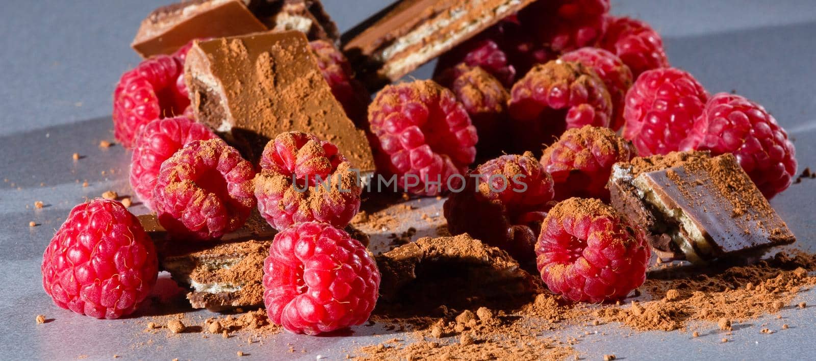 red Raspberry fruit on gray background chocolate