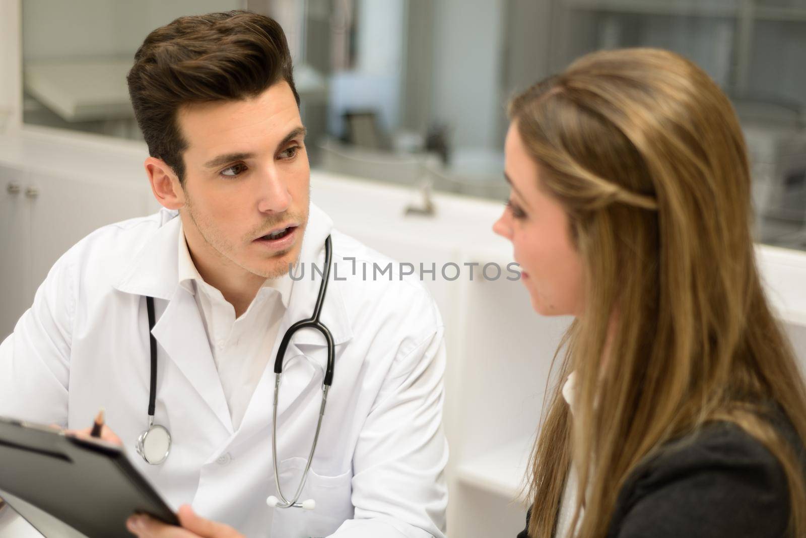 Portrait of a doctor listening to patient explaining her painful in his office